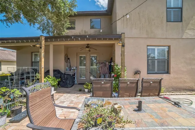 a view of a house with backyard and sitting area