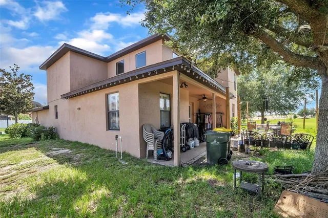 a view of a house with backyard sitting area and garden
