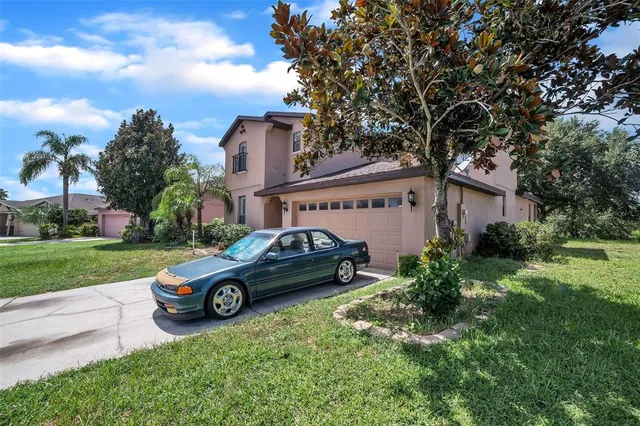a car parked in front of a house with a garden