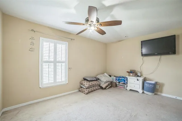 a view of a livingroom with a window and a ceiling fan