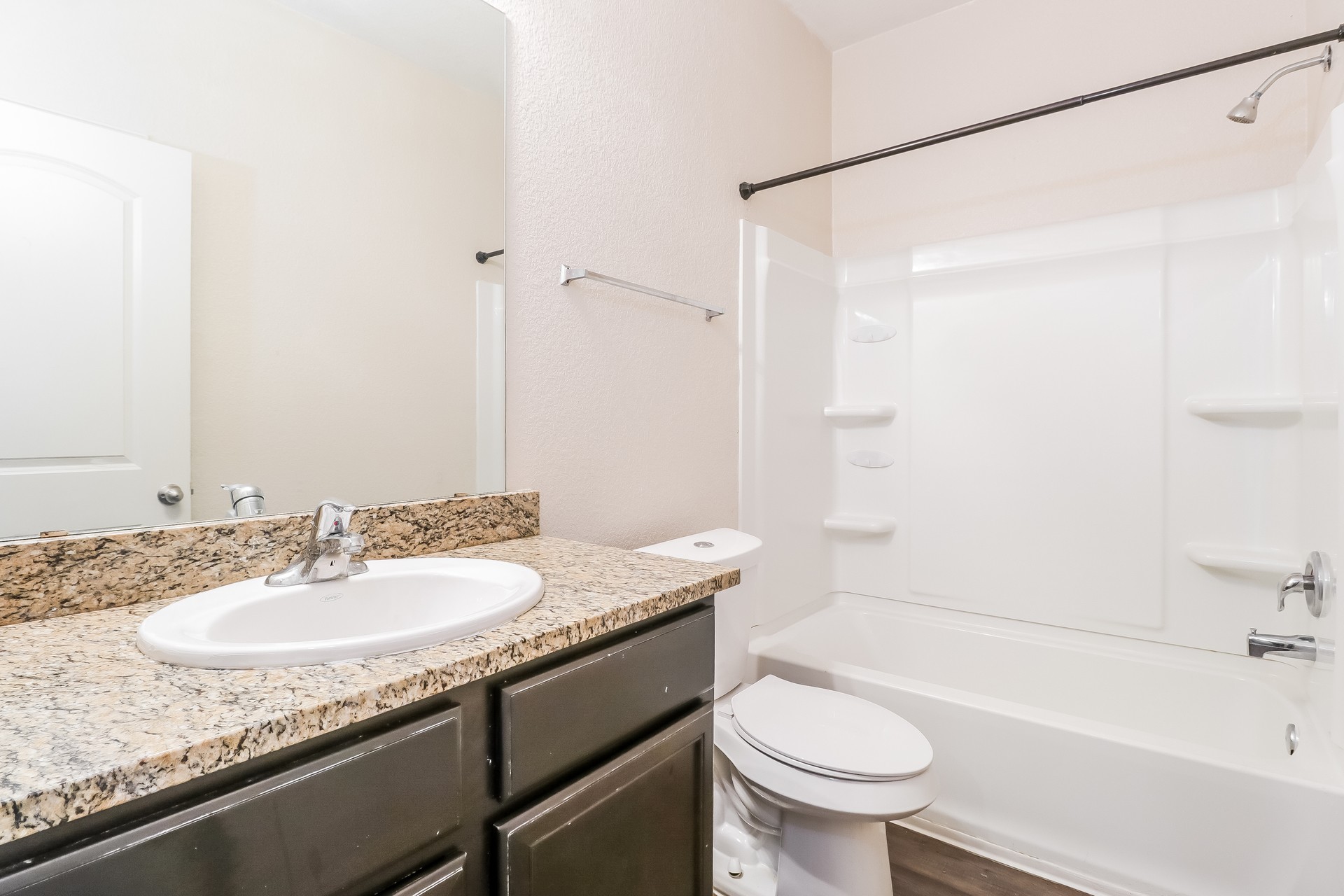 20017 Hubert R Humphrey Road Manor, TX 78653 - Photo 19 of 27 Granite counters and dark wood cabinetry provide functionality in this well-maintained bath.