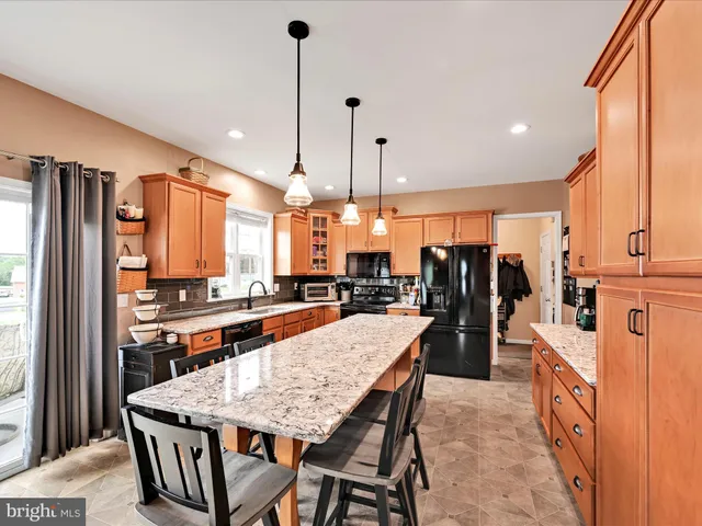 a kitchen with lots of counter space windows and a sink