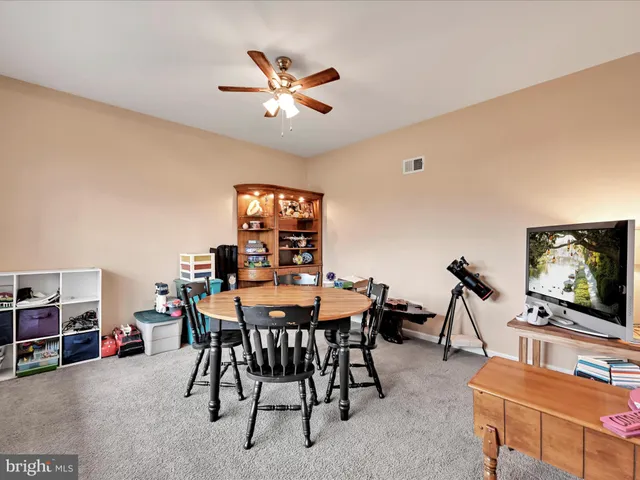 a view of a dining room with furniture and window