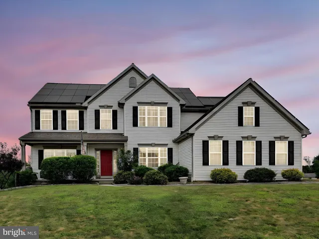 a view of a green field with wooden fence