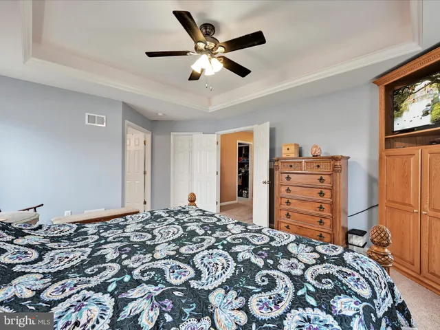 a spacious bathroom with a tub sink and mirror