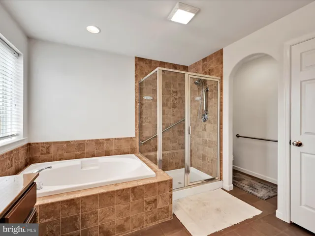 a view of walk in closet with clothes