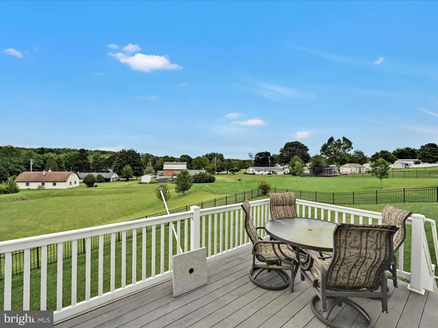 a view of outdoor space with green field and trees