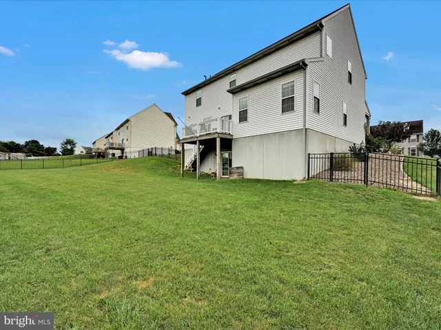 a view of a house with a backyard and porch