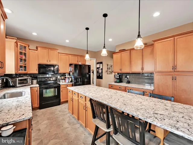 a large kitchen with a table and chairs