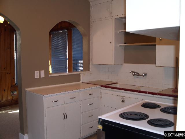 1065 Locust Street Reno, NV 89502 - Photo 3 of 6 a kitchen with a sink and a stove with wooden floor