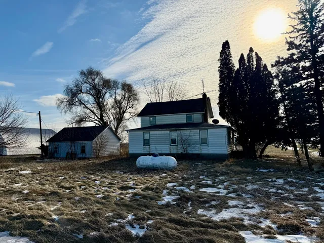 a backyard of a house with table and chairs