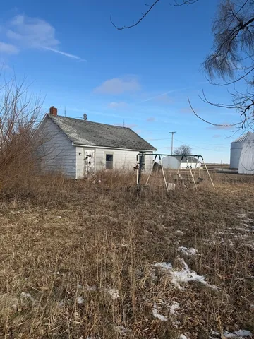 a view of a backyard with table and chairs with wooden fence