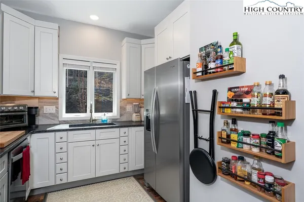 a kitchen with refrigerator and cabinets