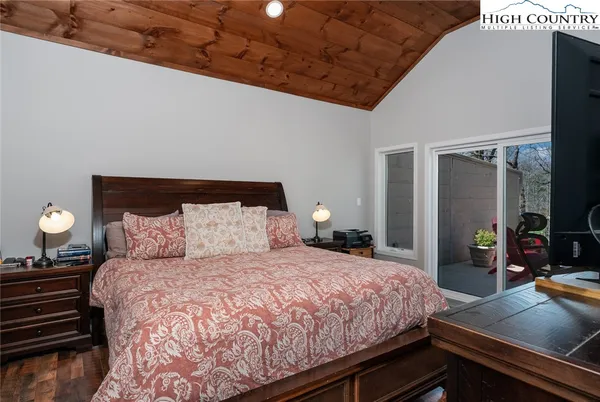 a bedroom with a bed and a dresser next to a window