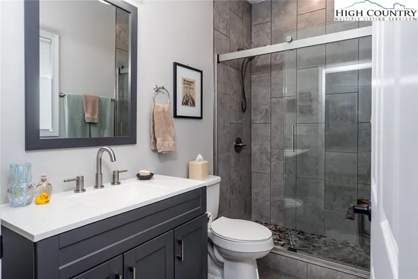 a spacious bedroom with two beds and painting on the wall