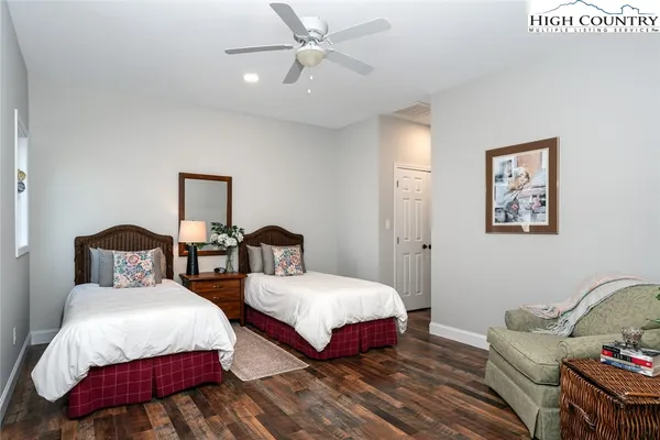 a bedroom with two beds and a night stand