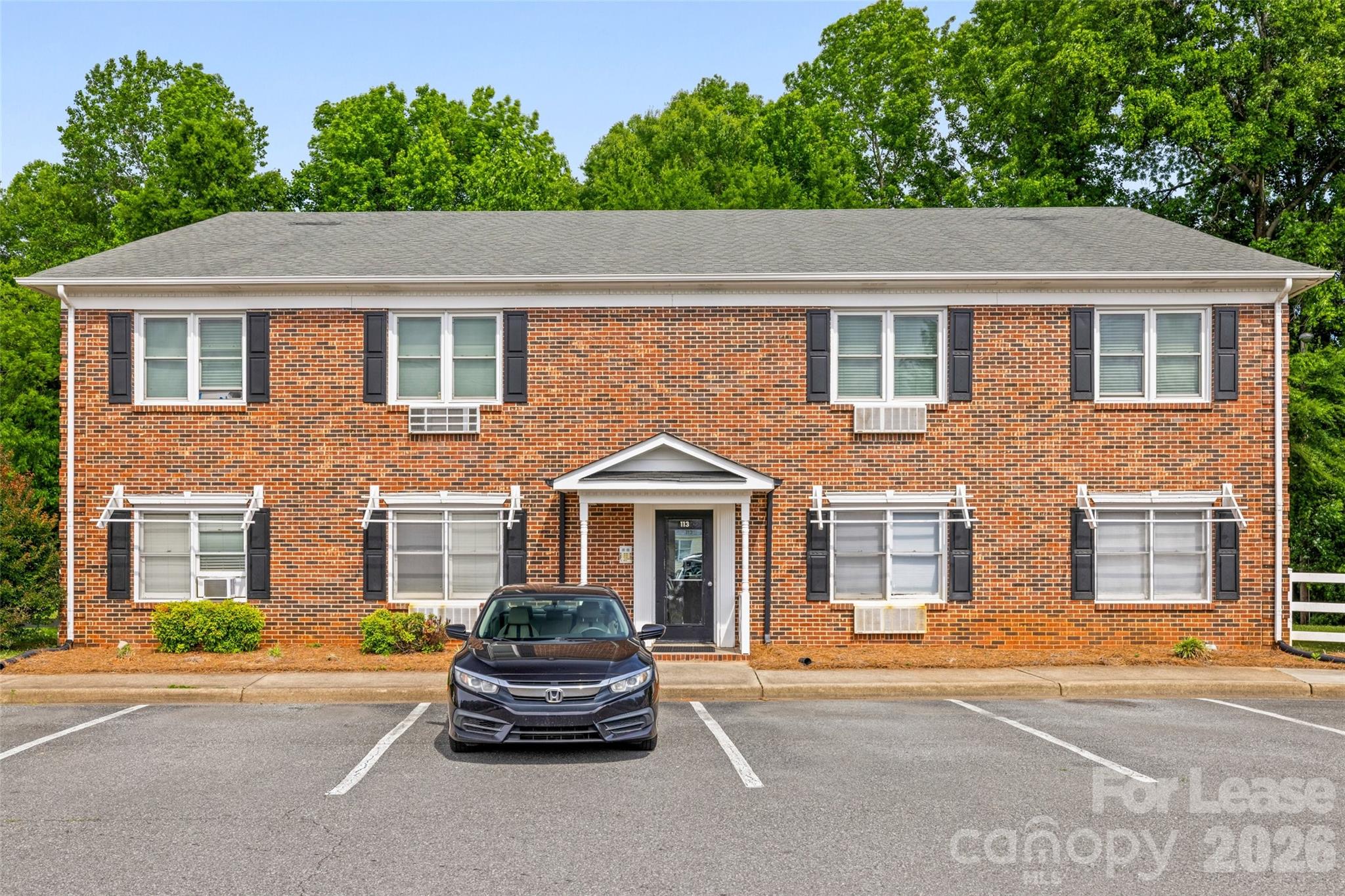 113 Stroupe Road, Unit E Gastonia, NC 28056 - Photo 1 of 33 a house that has a lot of windows on it