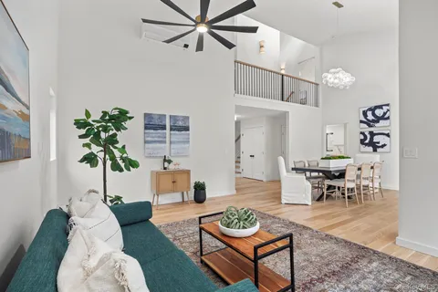 a living room with furniture potted plant and a chandelier
