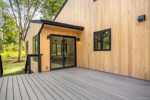 a view of a house with wooden floor and a yard