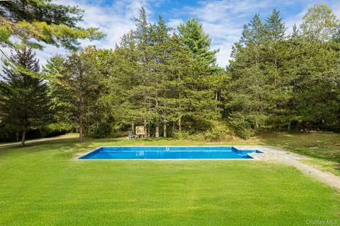 a view of swimming pool with an outdoor space and seating area