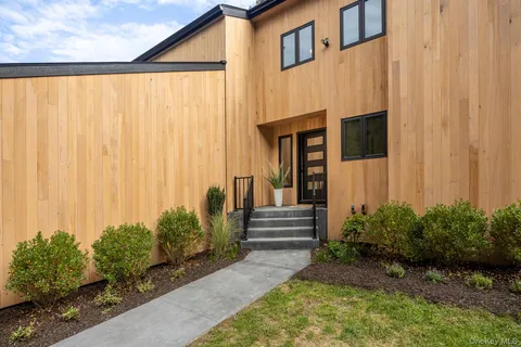 a front view of a house with a garden