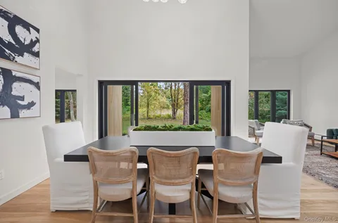 a dining room with furniture a rug and wooden floor