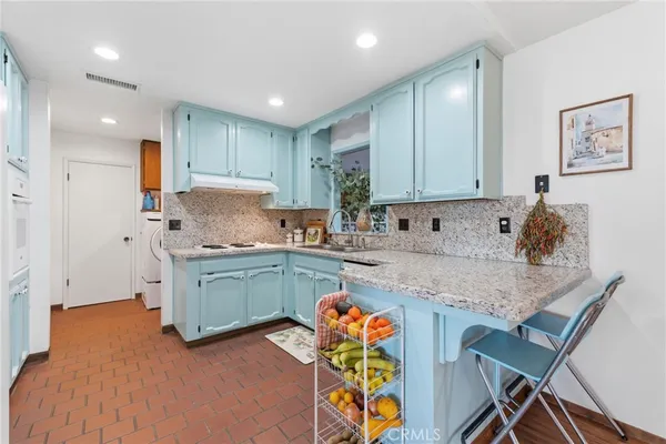 a bathroom with a sink a toilet and shower curtain