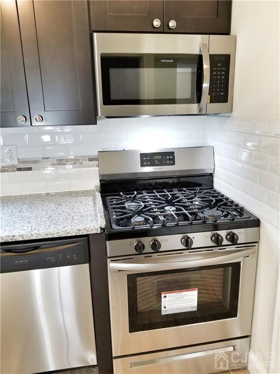 8503 Hana Road Edison, NJ 08817 - Photo 12 of 18 a stove top oven sitting inside of a kitchen