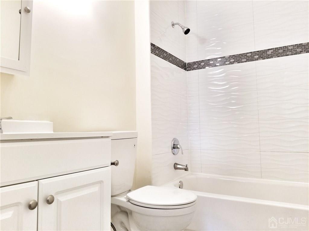 8503 Hana Road Edison, NJ 08817 - Photo 3 of 18 a bathroom with a toilet and a bathtub