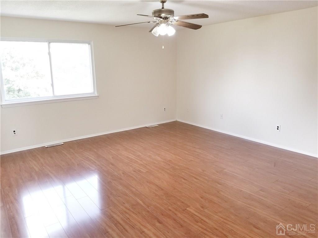 8503 Hana Road Edison, NJ 08817 - Photo 10 of 18 wooden floor in an empty room with a window