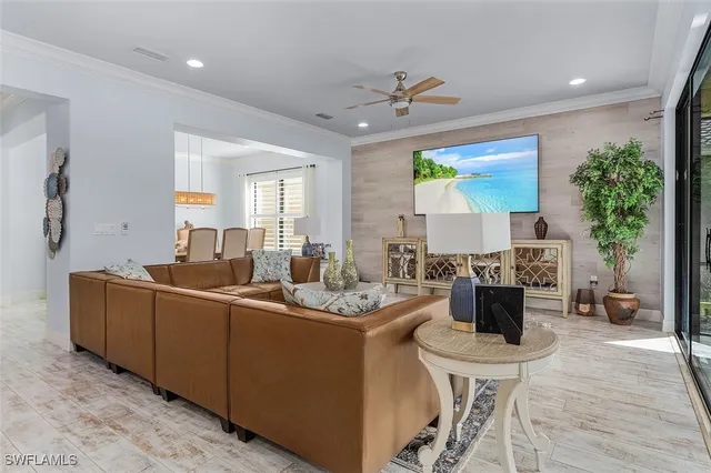a living room with furniture and a chandelier