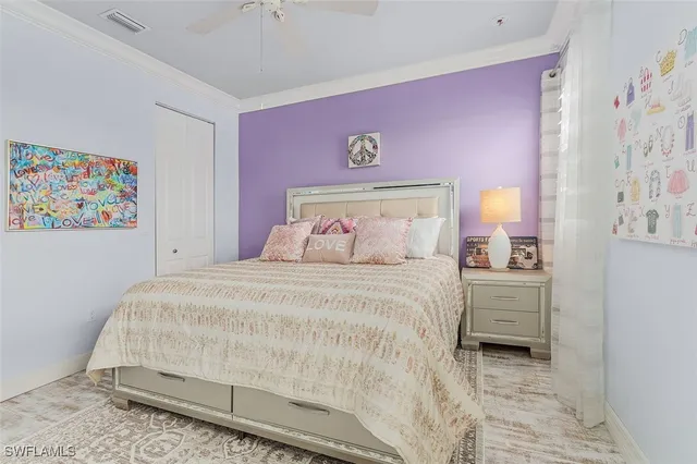 a bedroom with a bed and a painting on the wall