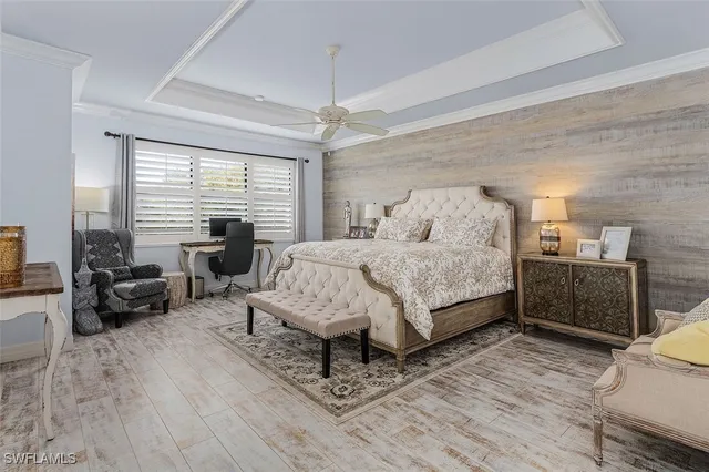 a bedroom with a bed couch and a large window