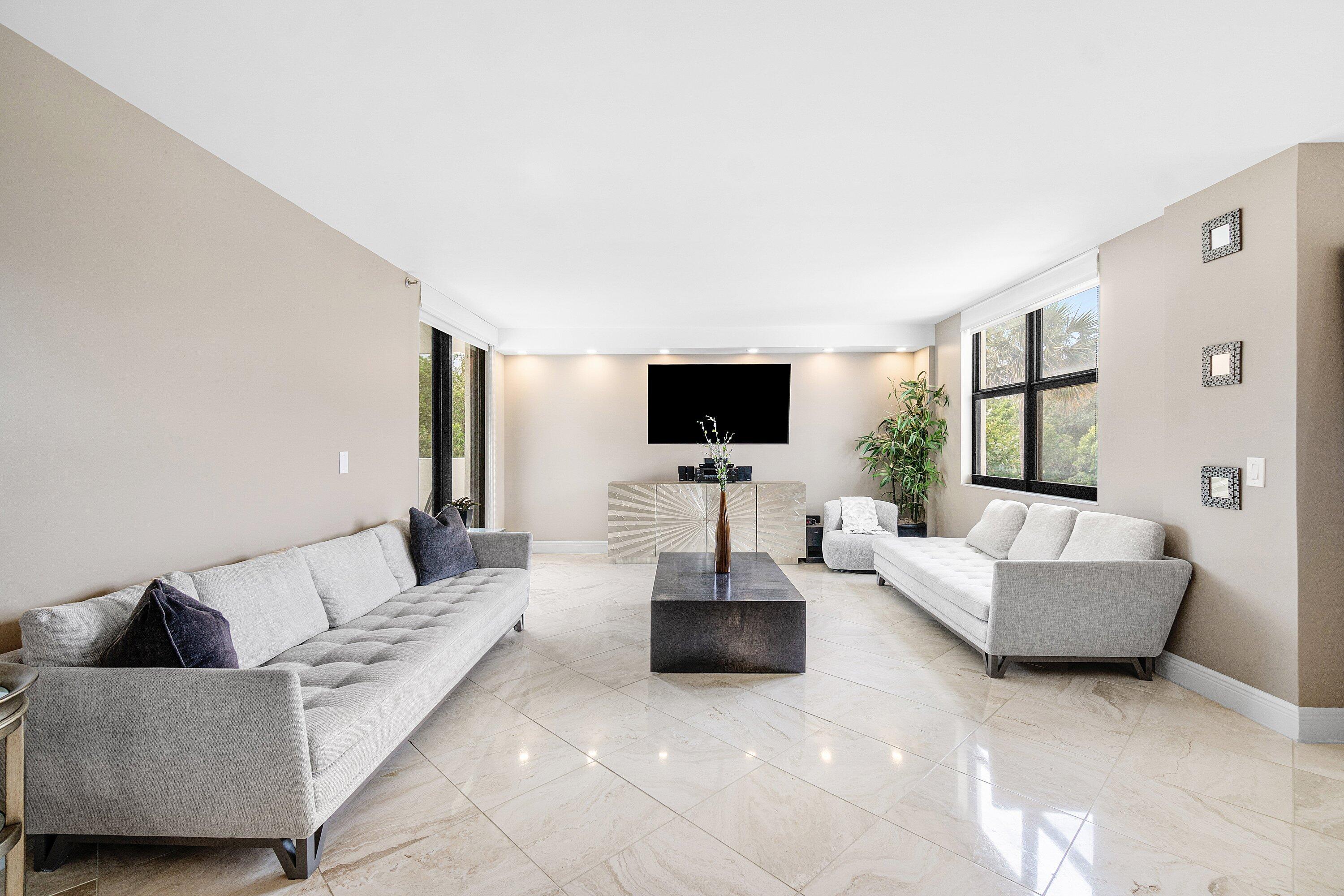 2001 North Ocean Boulevard, Unit 305 Boca Raton, FL 33431 - Photo 11 of 61 a living room with furniture and a flat screen tv