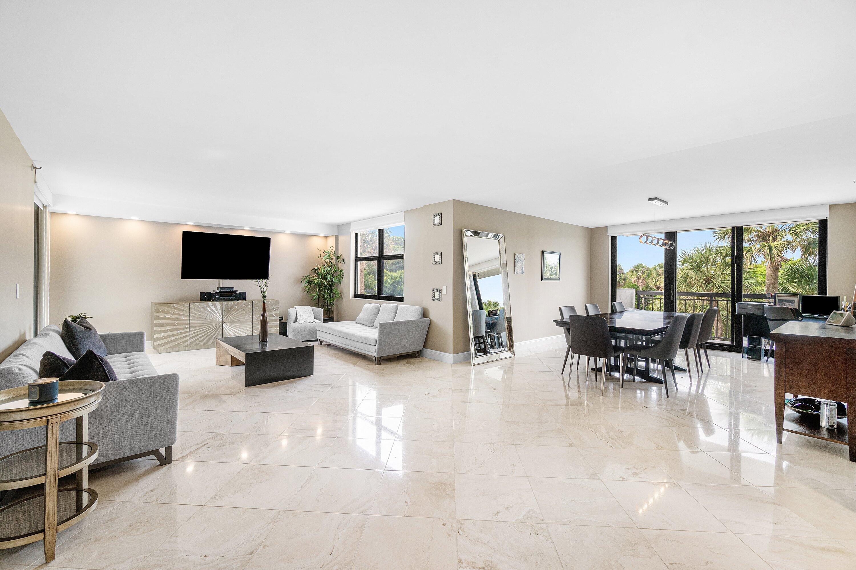 2001 North Ocean Boulevard, Unit 305 Boca Raton, FL 33431 - Photo 12 of 61 a living room with furniture and a flat screen tv