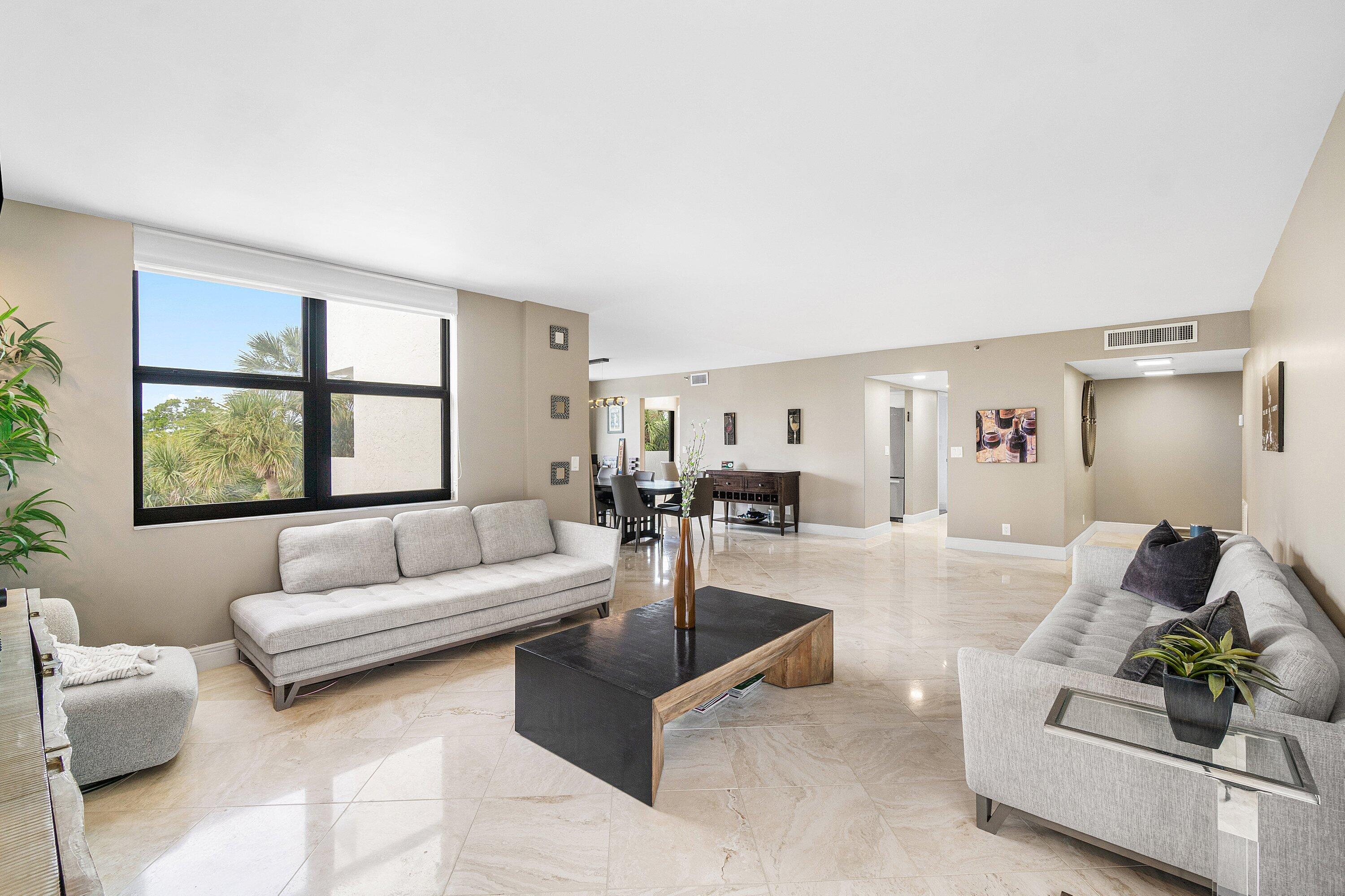 2001 North Ocean Boulevard, Unit 305 Boca Raton, FL 33431 - Photo 13 of 61 a living room with furniture and a large window