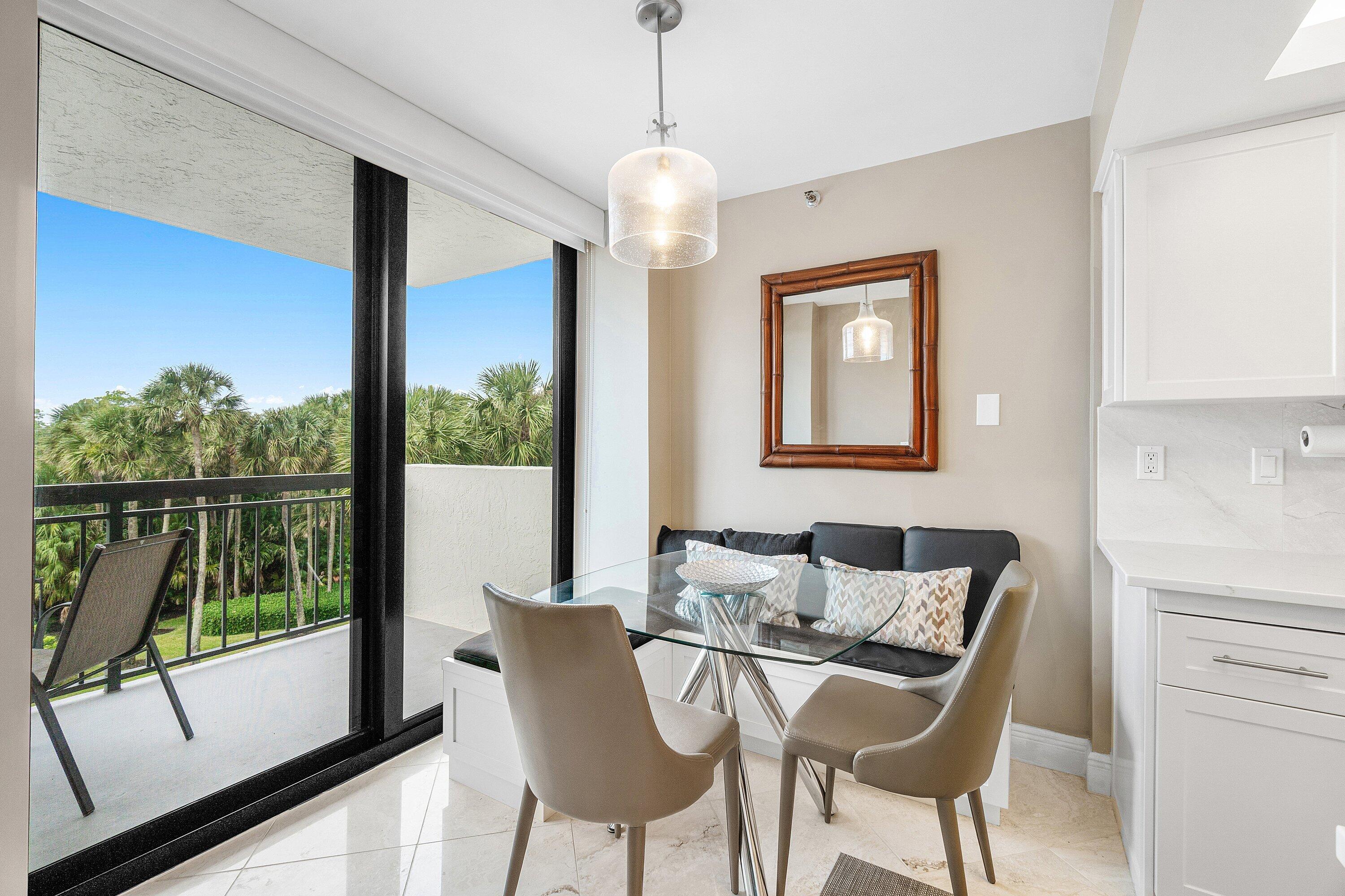 2001 North Ocean Boulevard, Unit 305 Boca Raton, FL 33431 - Photo 25 of 61 a dining room with furniture and large windows
