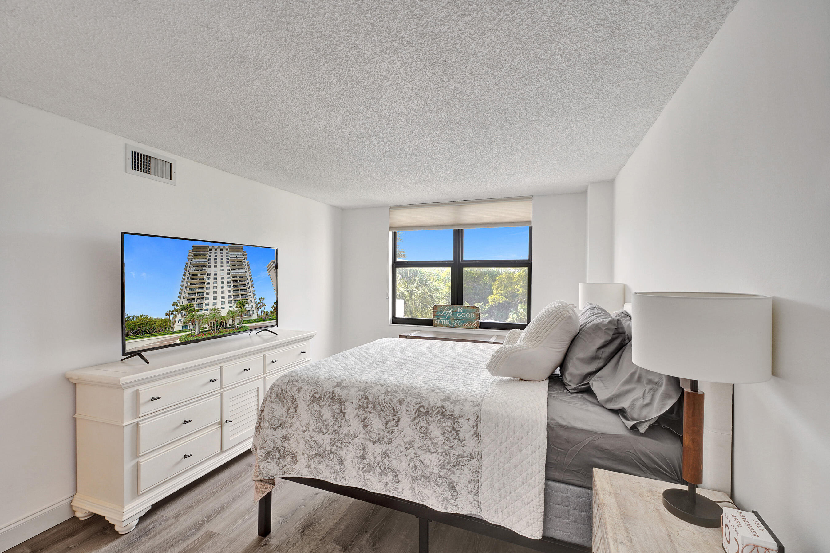 2001 North Ocean Boulevard, Unit 305 Boca Raton, FL 33431 - Photo 34 of 61 a bedroom with a bed and a flat screen tv