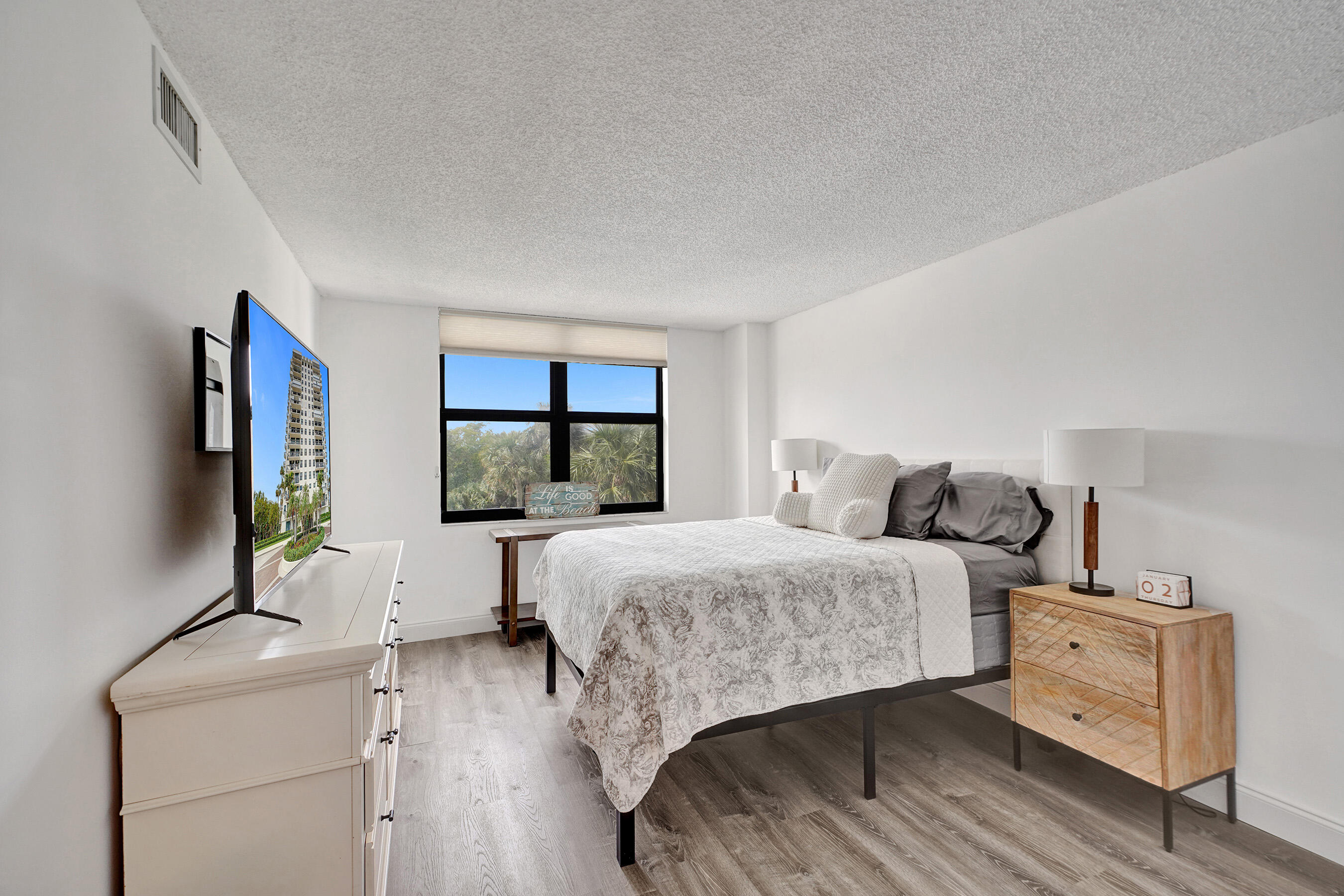 2001 North Ocean Boulevard, Unit 305 Boca Raton, FL 33431 - Photo 35 of 61 a bedroom with a bed and a window