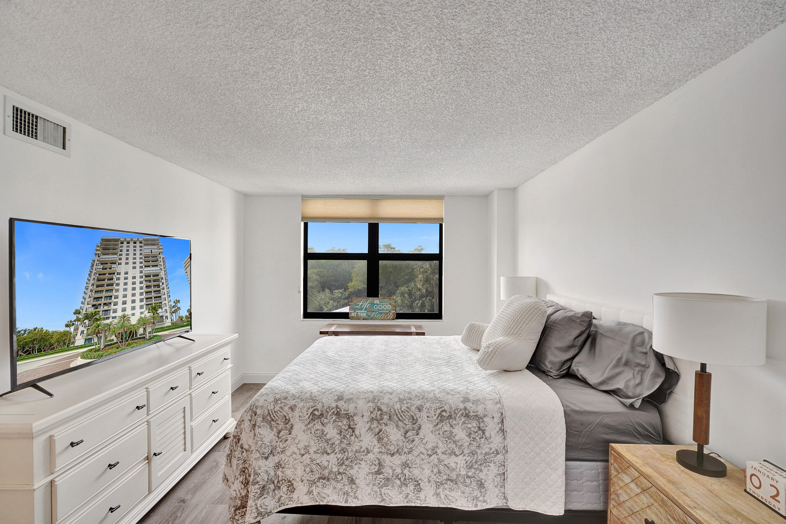 2001 North Ocean Boulevard, Unit 305 Boca Raton, FL 33431 - Photo 38 of 61 a bedroom with a large bed and a window