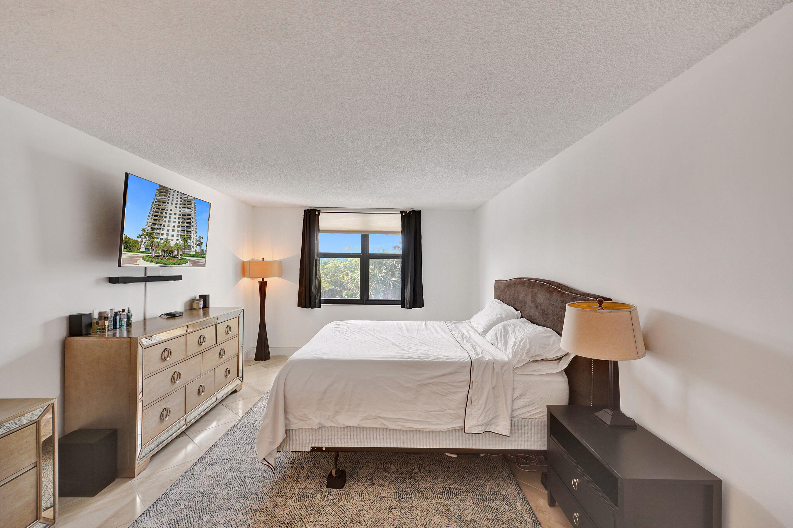 2001 North Ocean Boulevard, Unit 305 Boca Raton, FL 33431 - Photo 39 of 61 a bedroom with a bed and a dresser in it