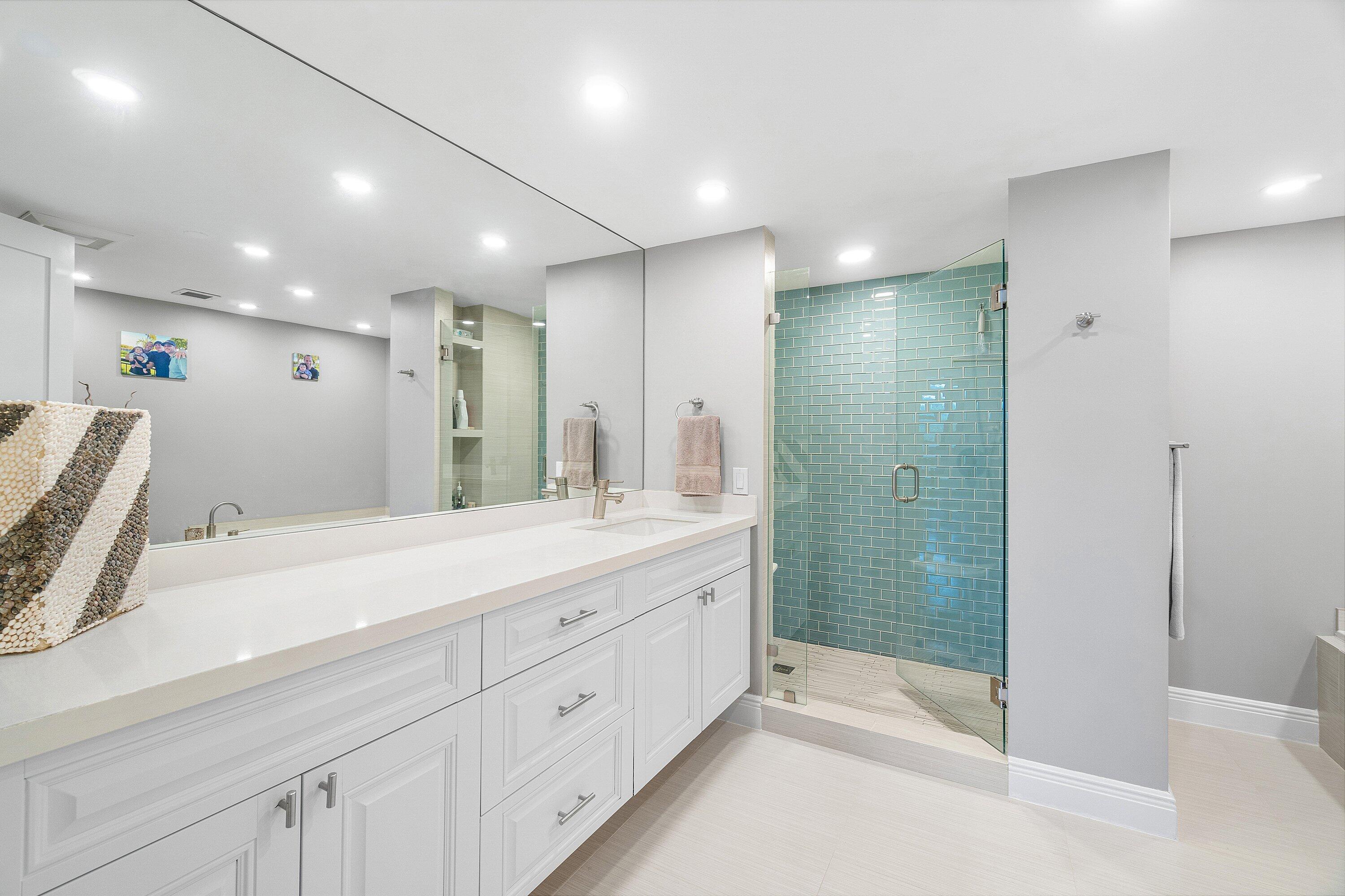 2001 North Ocean Boulevard, Unit 305 Boca Raton, FL 33431 - Photo 45 of 61 a bathroom with a shower sink and mirror
