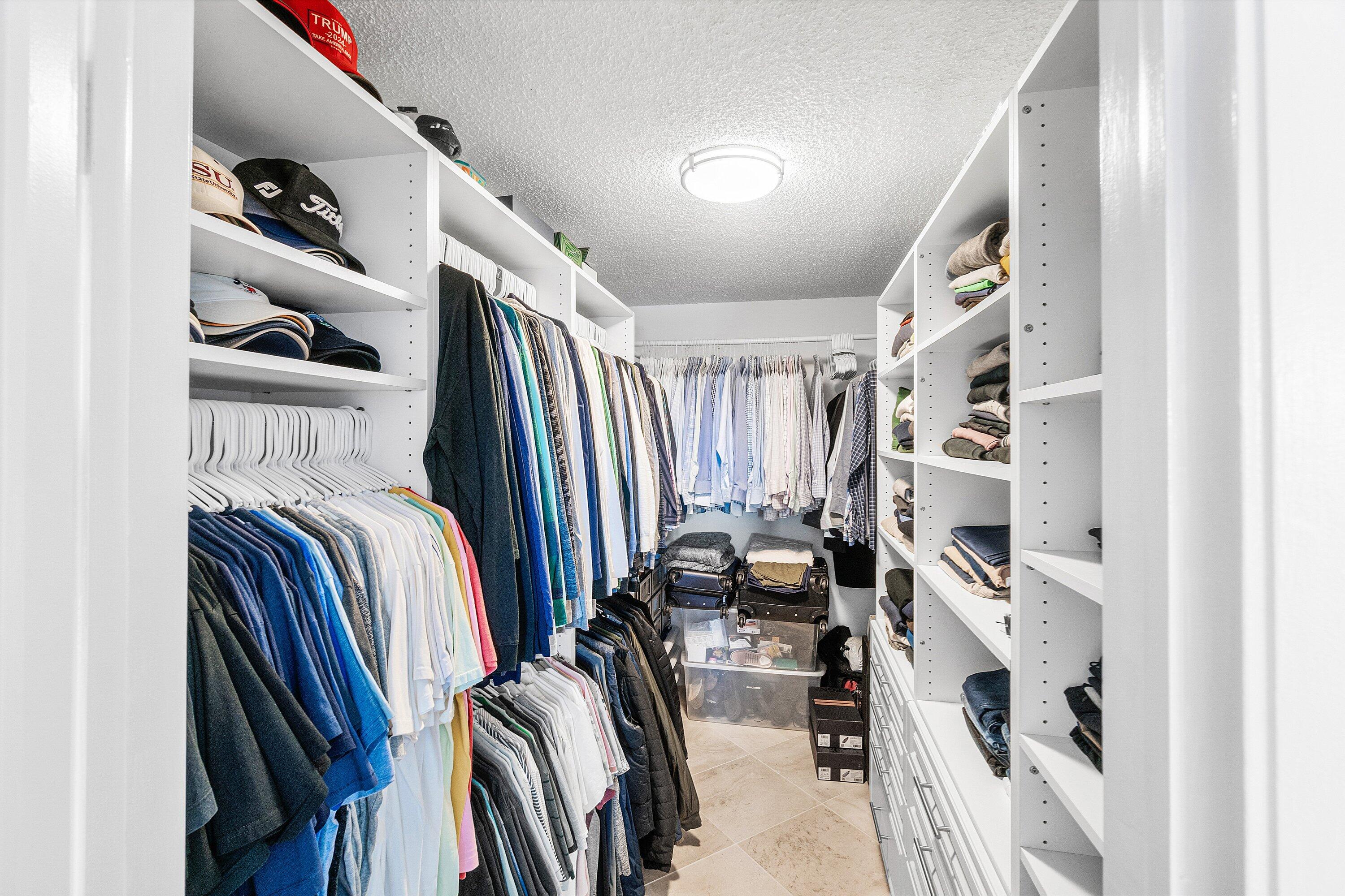 2001 North Ocean Boulevard, Unit 305 Boca Raton, FL 33431 - Photo 49 of 61 a view of walk in closet with clothes and shoes