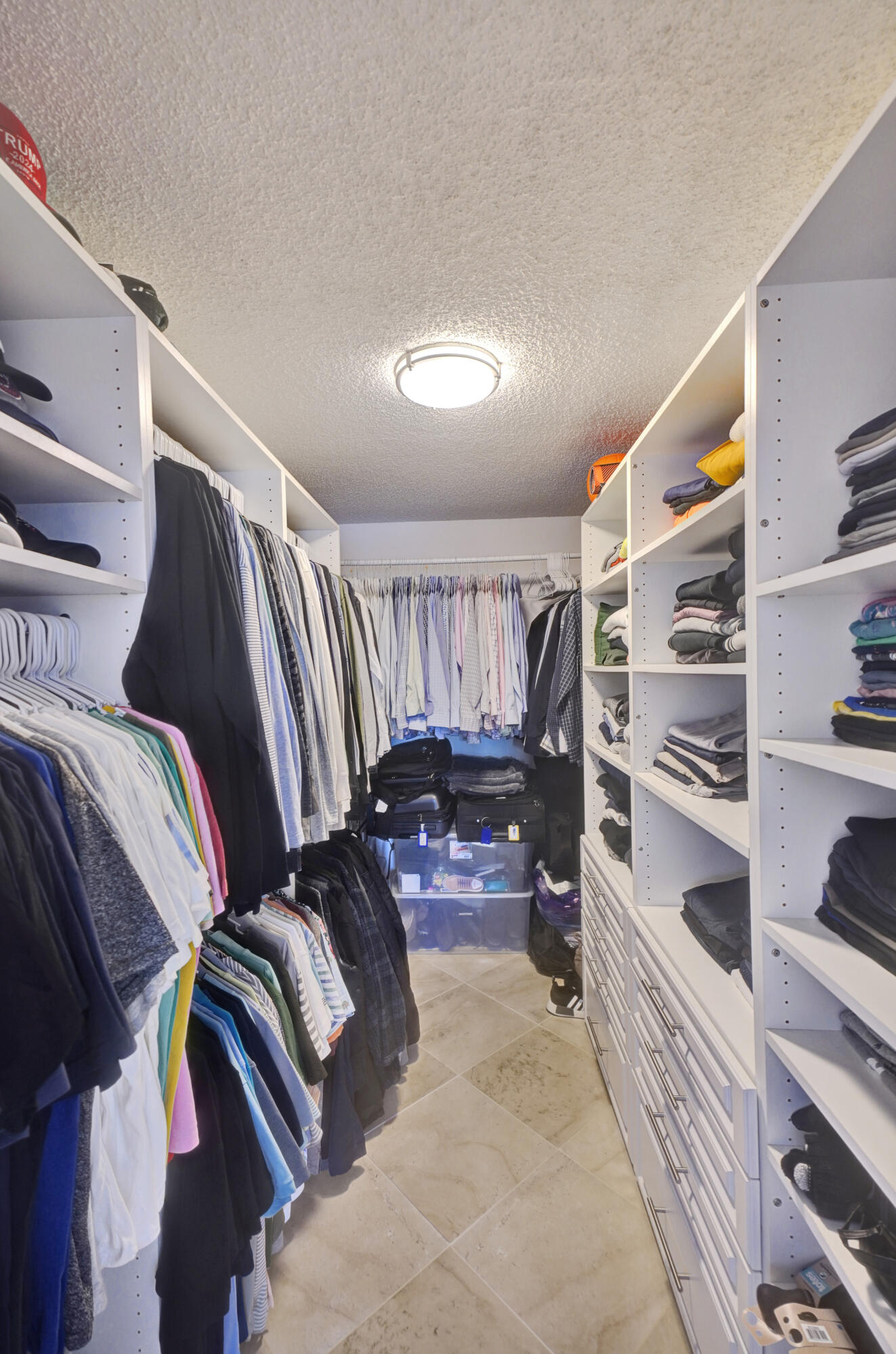 2001 North Ocean Boulevard, Unit 305 Boca Raton, FL 33431 - Photo 50 of 61 a view of walk in closet with clothes and shoes