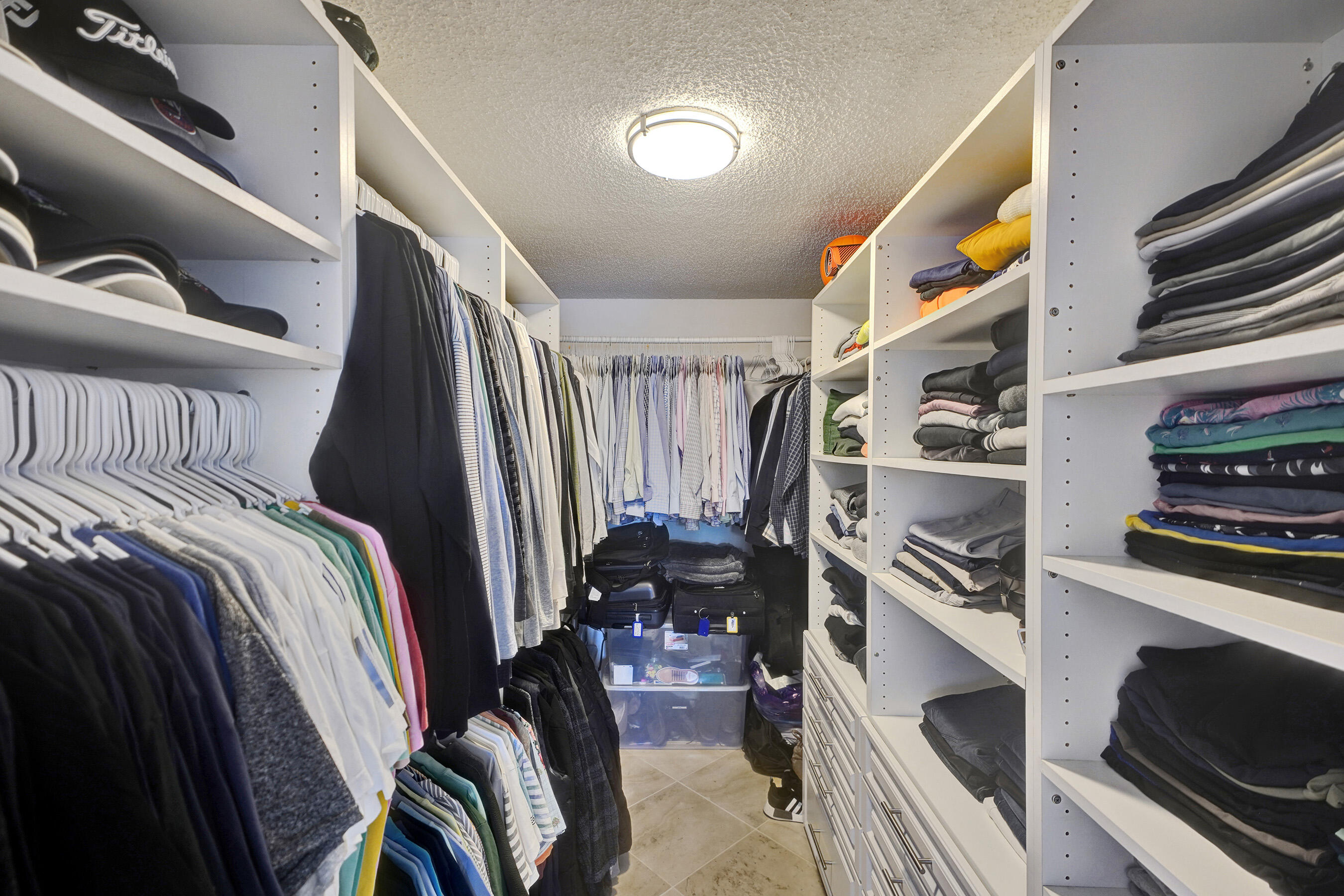 2001 North Ocean Boulevard, Unit 305 Boca Raton, FL 33431 - Photo 51 of 61 a view of walk in closet with clothes and shoes