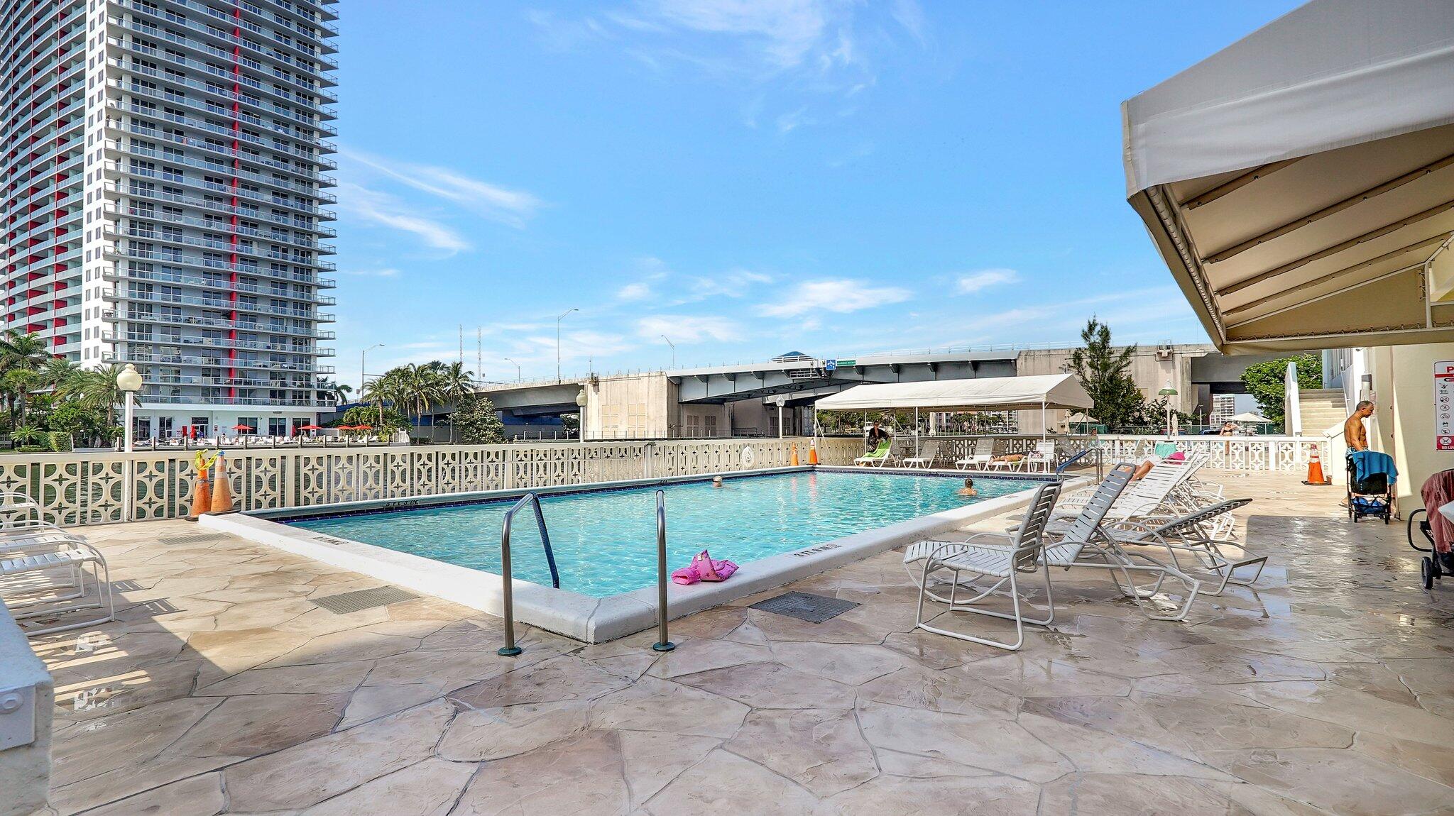 1825 South Ocean Drive, Unit 908 Hallandale Beach, FL 33009 - Photo 1 of 20 a view of roof deck with a barbeque and wooden stairs