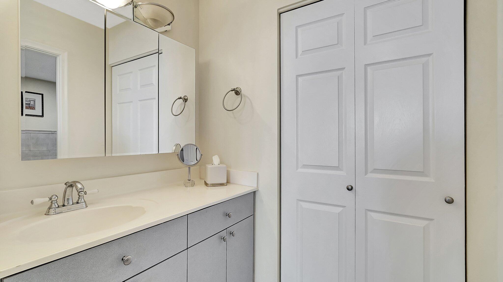 1825 South Ocean Drive, Unit 908 Hallandale Beach, FL 33009 - Photo 17 of 20 a bathroom with a double vanity sink and a mirror