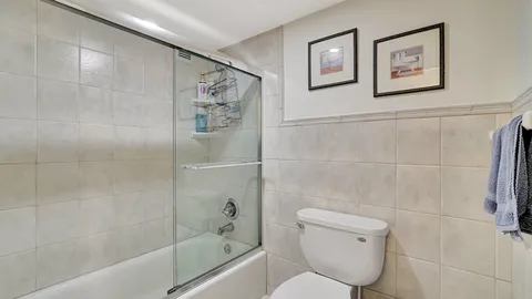 a bathroom with a toilet and a shower