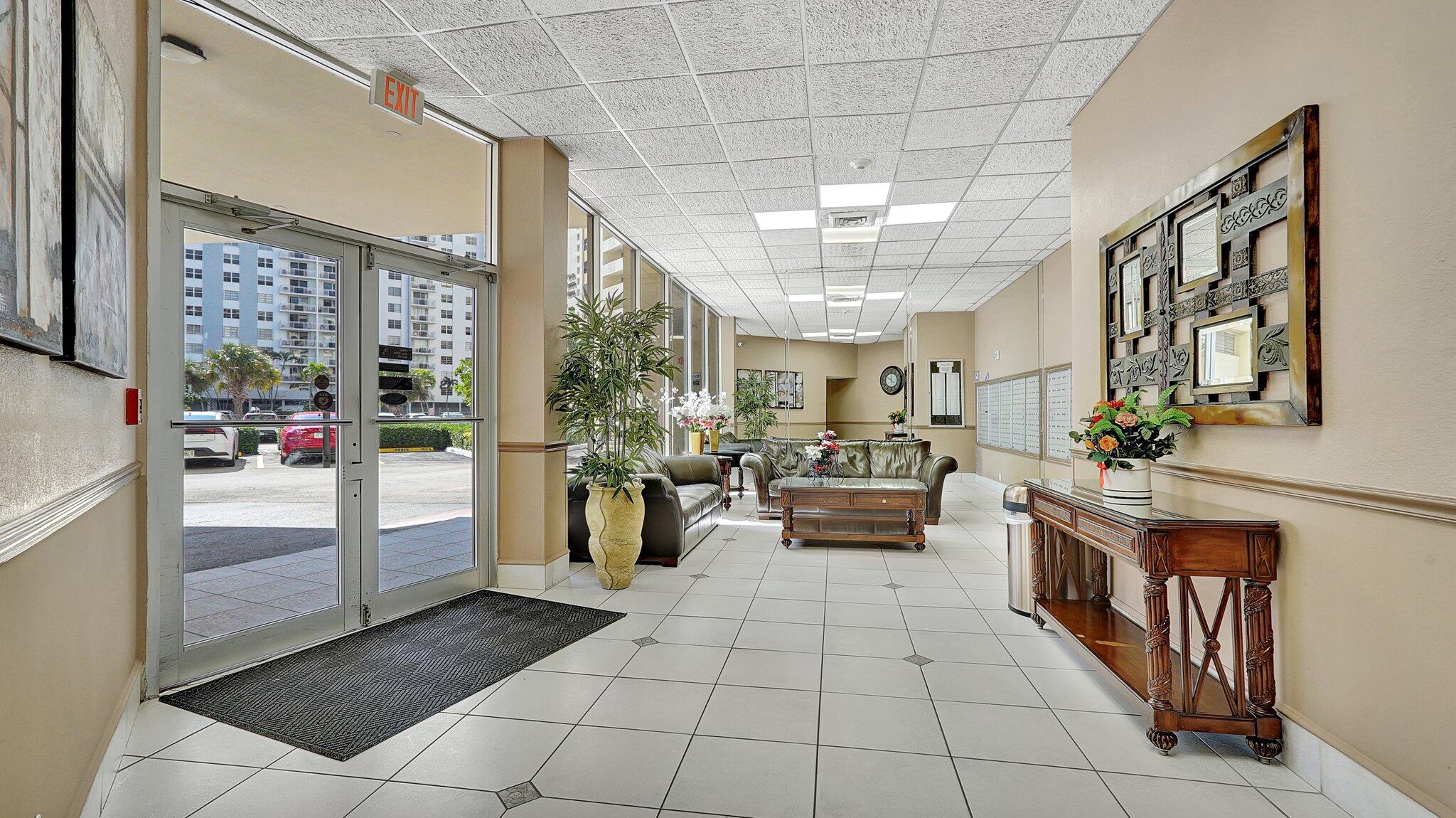 1825 South Ocean Drive, Unit 908 Hallandale Beach, FL 33009 - Photo 3 of 20 a lobby with furniture and a potted plant