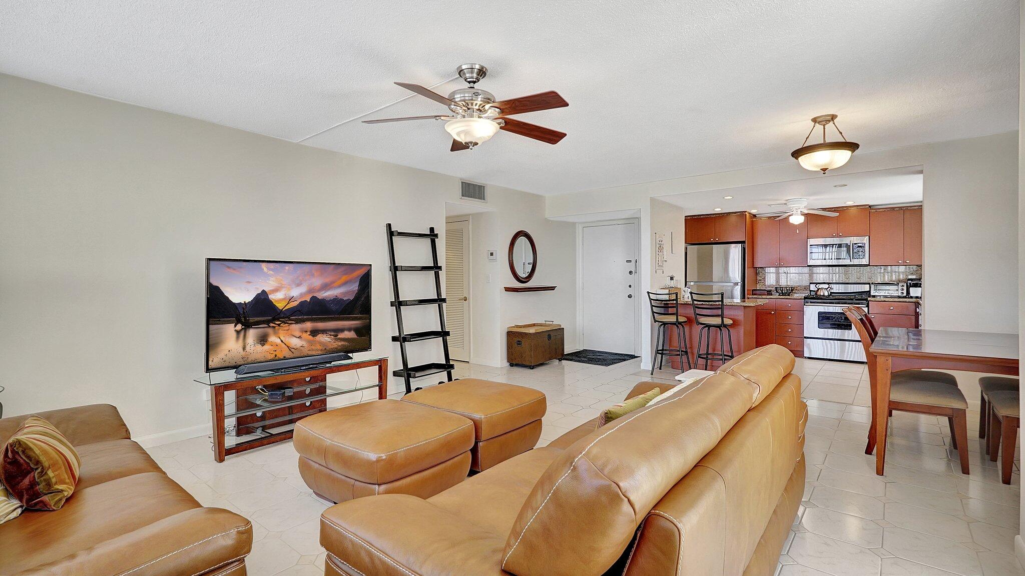 1825 South Ocean Drive, Unit 908 Hallandale Beach, FL 33009 - Photo 8 of 20 a living room with furniture and a flat screen tv